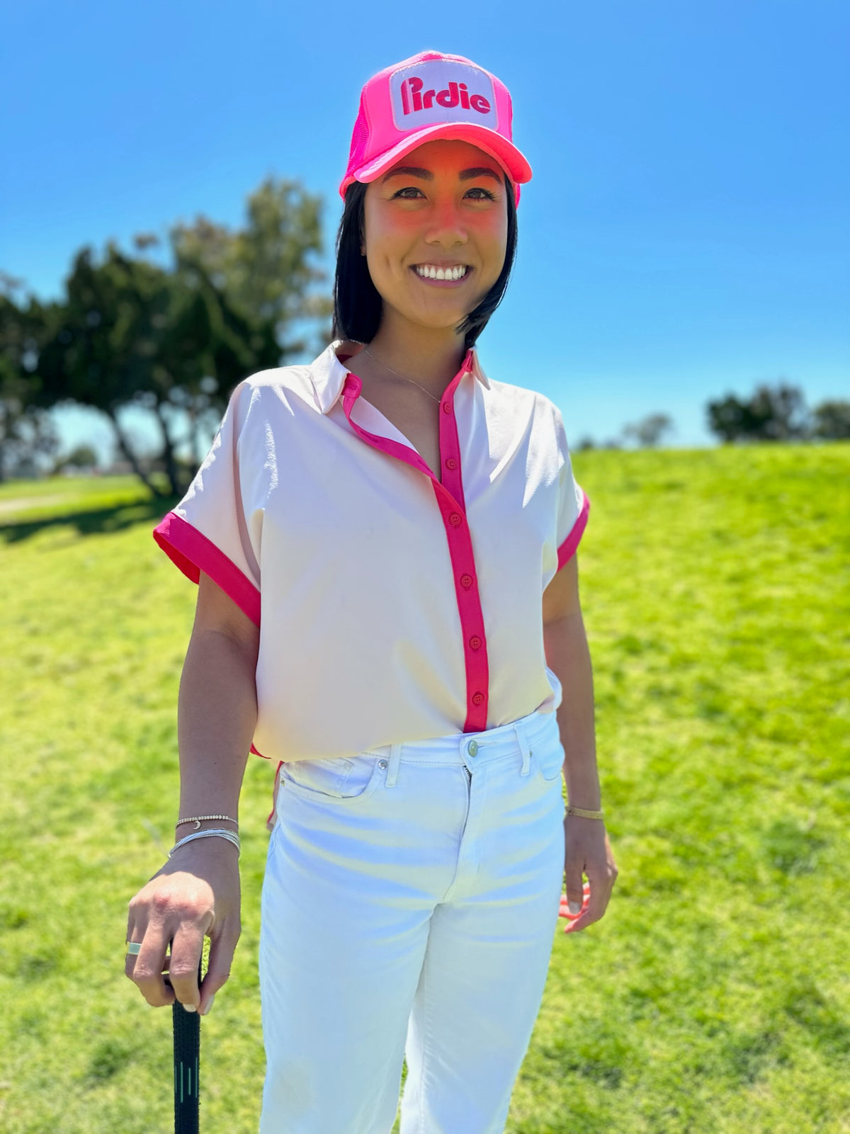 Model wearing Pink Caddy Camp golf shirt with Hot Pink Pirdie golf trucker hat.