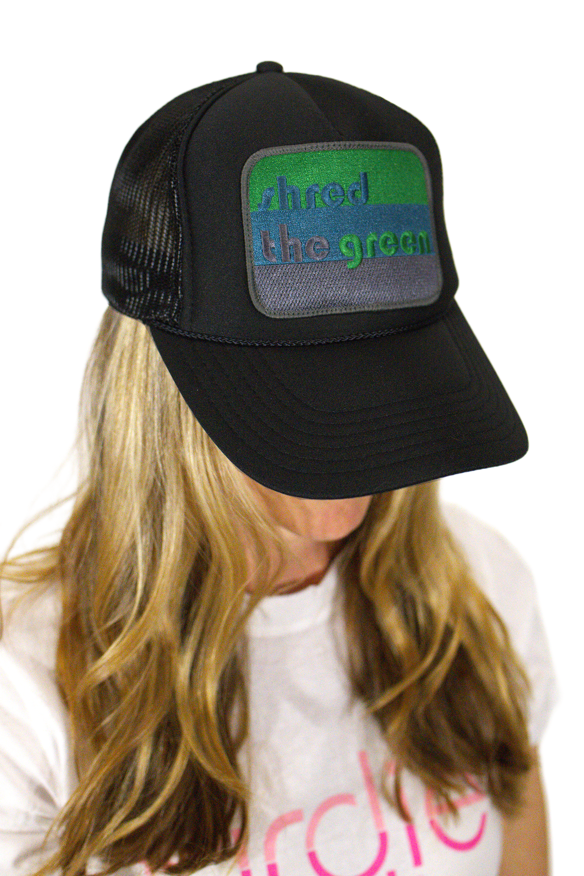 Model wearing black shred the green golf trucker hat